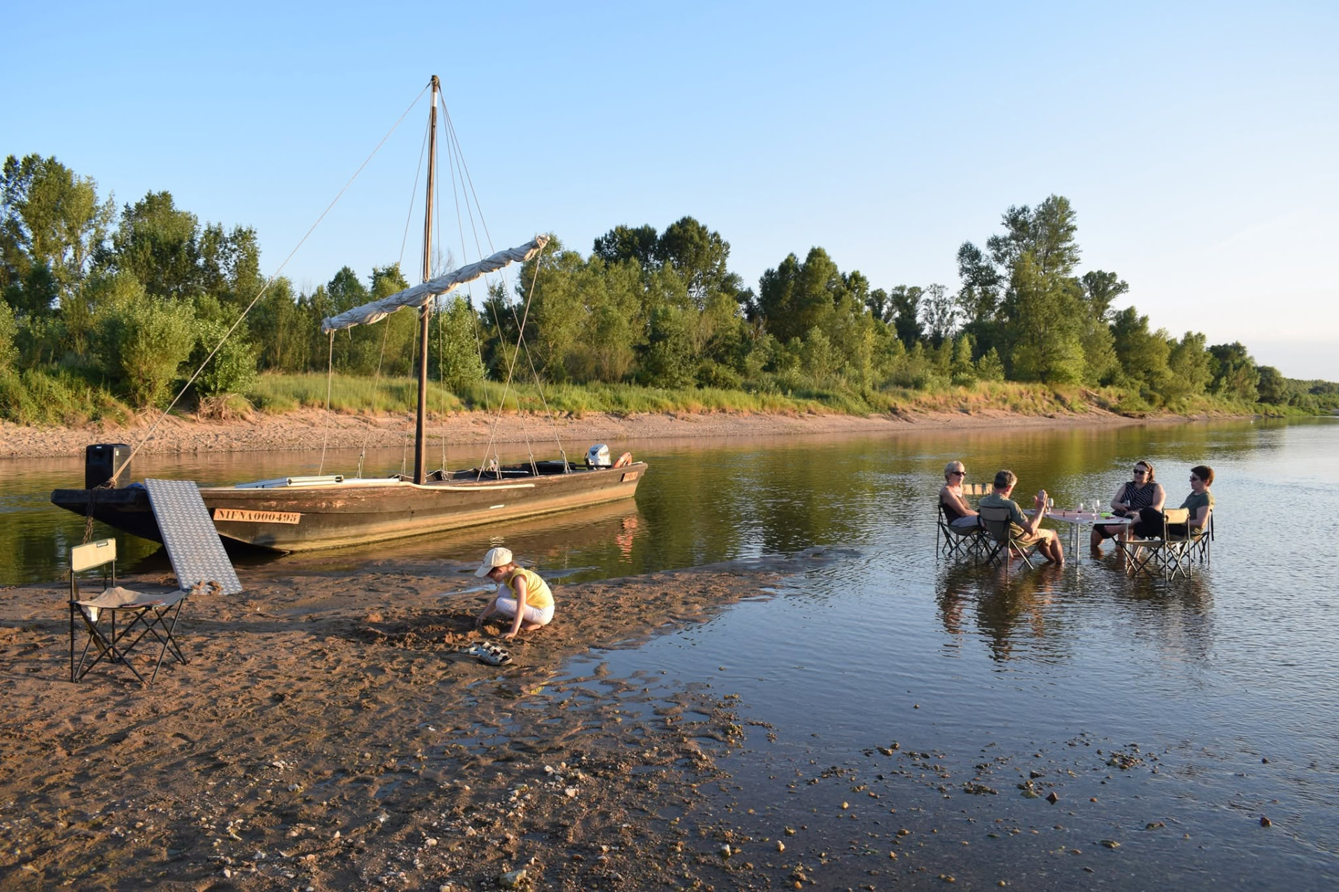 Traditional wooden boats moored on a sandy riverbank