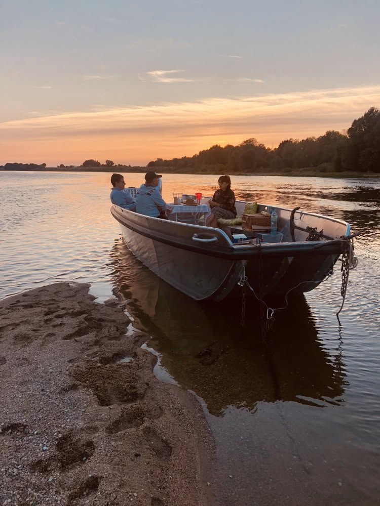 A small boat on a calm river at sunset